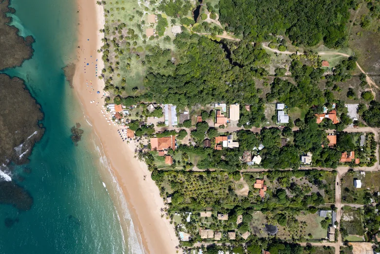 Aerial view of the beach and homes of Taipu de Fora, between the sea and the forest